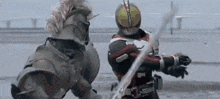 a man in a knight 's armor is fighting another man in a masked rider costume .