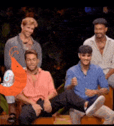 a group of men are sitting on a wooden bench with a shrimp behind them and a cartoon shrimp .