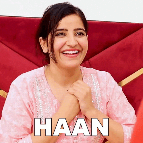 a woman in a pink shirt is smiling with the word haan written on the bottom