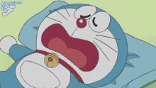a cartoon of doraemon laying on a pillow with his mouth open
