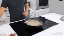 a man is cooking on a stove with the words made in animatica on the bottom of the screen