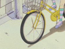 a girl is riding a yellow bicycle with a basket