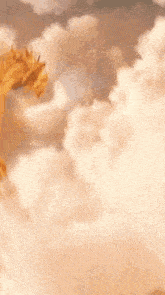 a gold dragon is flying through the clouds .
