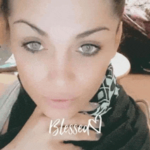 a close up of a woman 's face with the words `` blessed '' written on the bottom .