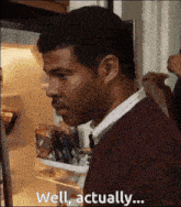 a man standing in front of a refrigerator with the words well actually