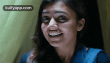 a close up of a woman making a funny face with her mouth open .