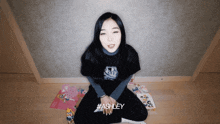 a woman wearing a black shirt that says ashley