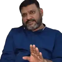 a man with a beard wearing a blue shirt is waving his hand