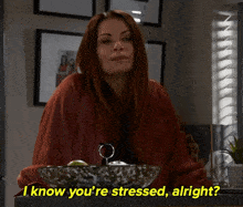 a woman sitting in front of a bowl with the words " i know you 're stressed alright " below her