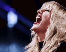 a woman is laughing with her mouth wide open