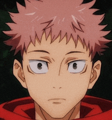 a close up of a man 's face with a red hoodie on