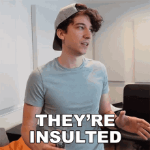 a young man wearing a hat and a t-shirt says they 're insulted