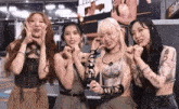 a group of girls are standing next to each other making funny faces .