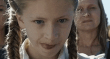 a young girl making a funny face with her tongue out
