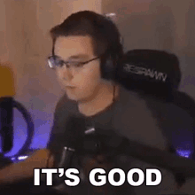 a man wearing glasses and headphones is sitting in front of a microphone and says `` it 's good '' .