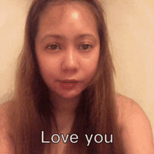 a woman with long hair has the words love you written on her face