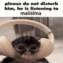 a monkey wearing headphones is listening to malisima .