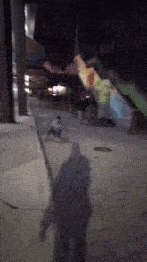 a shadow of a person is cast on a concrete surface