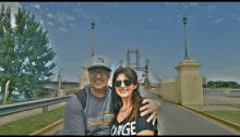 a man and a woman are posing for a picture with a sign that says chau 2015