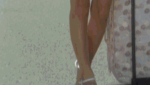 a woman in a blue skirt is walking with a suitcase in the background