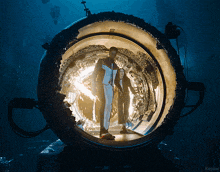 a man and a woman are walking through a tunnel that says kepler on it