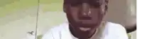a close up of a man 's face with a beard and a white shirt .
