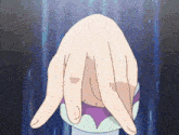 a person 's hand is holding a purple and white object