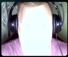 a man wearing headphones has a white face on his face