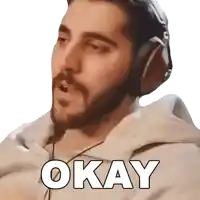 a man with a beard wearing headphones says okay .
