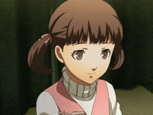 a little girl with pigtails is wearing a pink sweater