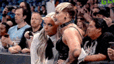 a group of women are sitting in a crowd at a wrestling match .