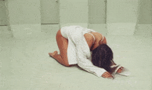 a woman in a white dress is laying on the ground