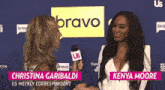 kenya moore is interviewing christina garibaldi in front of a bravo sign