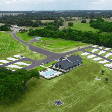 an aerial view of a residential area with a house and pool