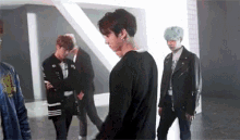 a group of young men are standing next to each other in a room in a room .