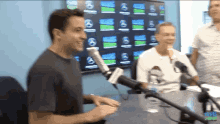 a man is talking into a microphone with a sign that says cbs radio on it