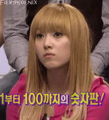 a girl with blonde hair is wearing a pink shirt with fieryphoenix written on the bottom