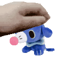a person is petting a stuffed animal that looks like a dog with a pink nose .