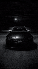 a black audi car is parked in the dark