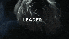 a close up of a person 's face with the word leader written on the bottom .