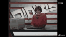 a woman is typing on a keyboard in front of a sign that says 11 k