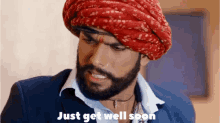 a man with a beard wearing a turban and a suit says " just get well soon "