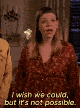 a woman in a red floral shirt says i wish we could but it 's not possible