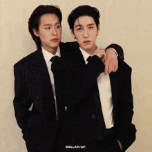 two men in suits are standing next to each other with the words bbillkin gif on the bottom right