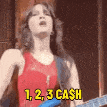 a woman singing and playing a guitar with 1,2,3 cash written in yellow