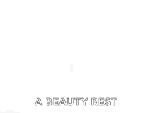 a black and white photo of a woman 's face with the words `` a beauty rest '' written below it .
