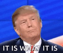 donald trump is wearing a suit and tie and making a funny face .