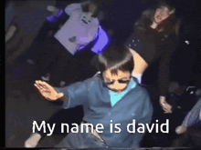 a boy dancing in a dark room with the words my name is david