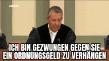 a man in a judge 's robe is sitting in front of a microphone in a courtroom with a caption .