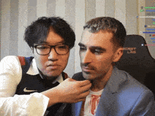 two men are looking at each other in front of a chair that says secret lab on it